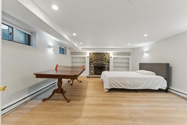 15 Park Ave, Newton, MA 02458 - bedroom with light wood-style flooring, baseboard heating, recessed lighting, and a fireplace