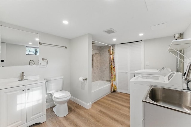 15 Park Ave, Newton, MA 02458 - bathroom with washer and dryer, toilet, recessed lighting, wood finished floors, and vanity