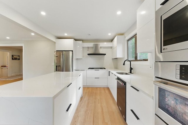 15 Park Ave, Newton, MA 02458 - kitchen with appliances with stainless steel finishes, modern cabinets, a sink, wall chimney exhaust hood, and recessed lighting