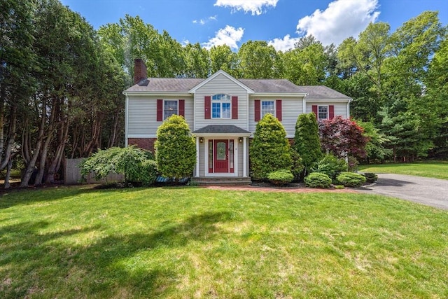 6 Willow Park, Wellesley, MA 02481 - view of front of home with a chimney, a front lawn, brick siding, and driveway