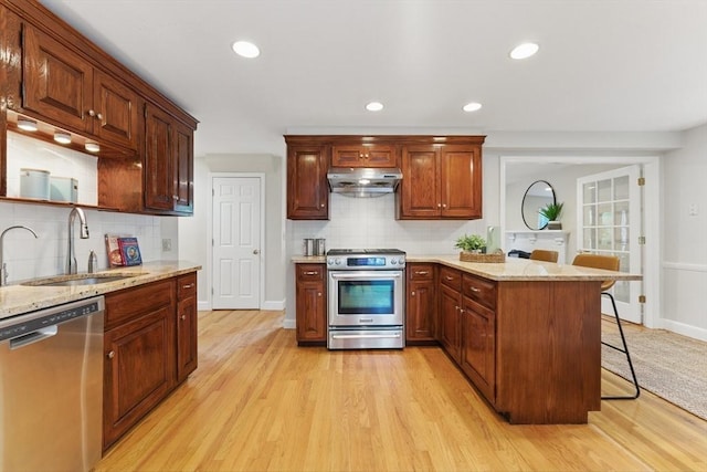 6 Willow Park, Wellesley, MA 02481 - kitchen featuring appliances with stainless steel finishes, under cabinet range hood, a sink, backsplash, and recessed lighting