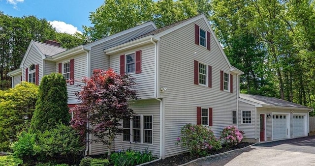 6 Willow Park, Wellesley, MA 02481 - view of home's exterior with a garage, driveway, and a chimney