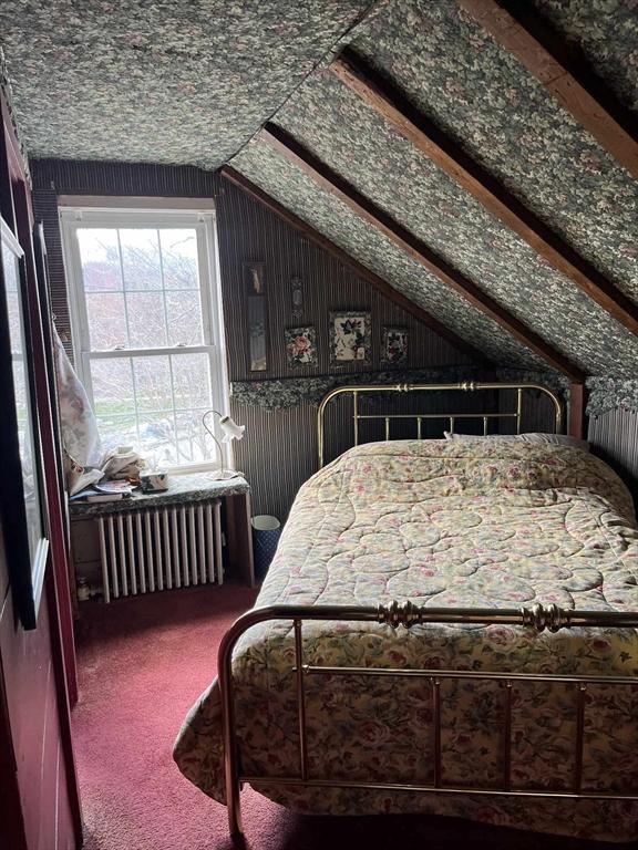 301 May St, Worcester, MA 01602 - carpeted bedroom with radiator heating unit and lofted ceiling