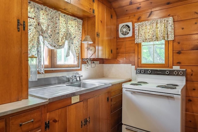 301 May St, Worcester, MA 01602 - kitchen featuring electric stove, brown cabinets, a sink, and light countertops