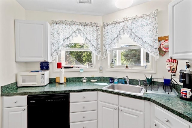 kitchen featuring white cabinetry, black dishwasher, white microwave, and a sink