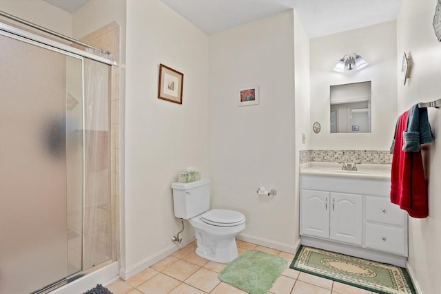 full bath featuring tile patterned floors, toilet, a shower stall, baseboards, and vanity