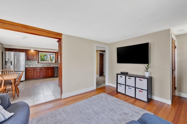 living room featuring baseboards and light wood finished floors