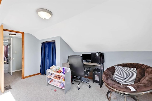 office space featuring carpet floors, baseboards, and vaulted ceiling