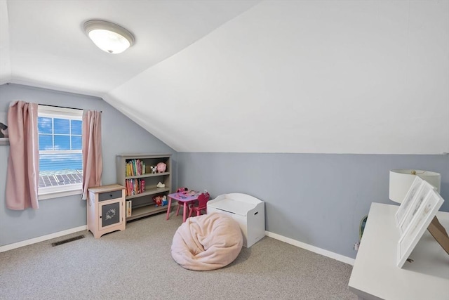 rec room with carpet floors, baseboards, visible vents, and vaulted ceiling