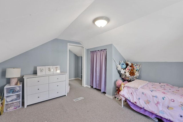 bedroom featuring vaulted ceiling, visible vents, baseboards, and carpet