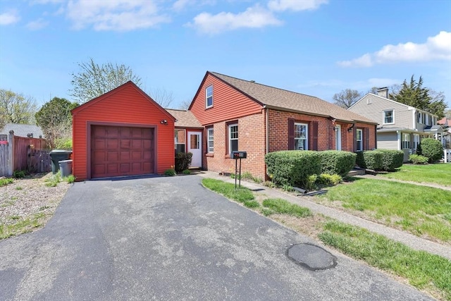 ranch-style house featuring brick siding, fence, aphalt driveway, an attached garage, and a shingled roof