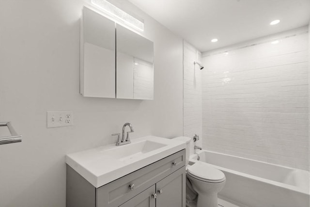 full bathroom with vanity, toilet, and tiled shower / bath