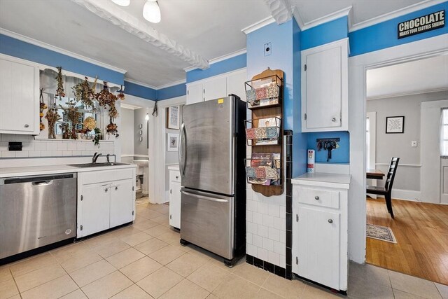 60 Brookfield Rd, Sturbridge, MA 01518 - kitchen with appliances with stainless steel finishes, crown molding, light countertops, light tile patterned floors, and white cabinets