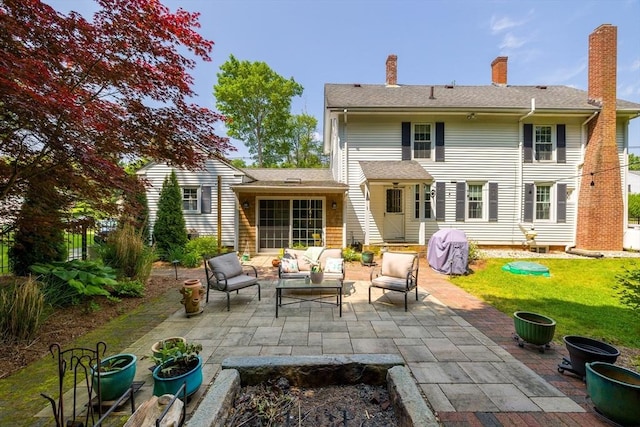 60 Brookfield Rd, Sturbridge, MA 01518 - rear view of house with outdoor lounge area, a patio area, a lawn, and a chimney