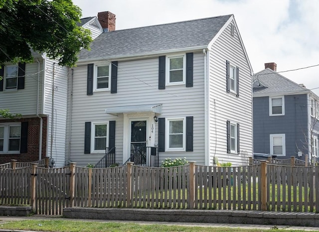 104 Bell Rock St, Malden, MA 02148 - view of front of home with a chimney, a fenced backyard, and a shingled roof