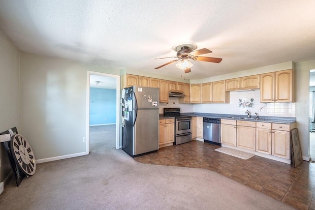 kitchen featuring light brown cabinetry, appliances with stainless steel finishes, and dark colored carpet