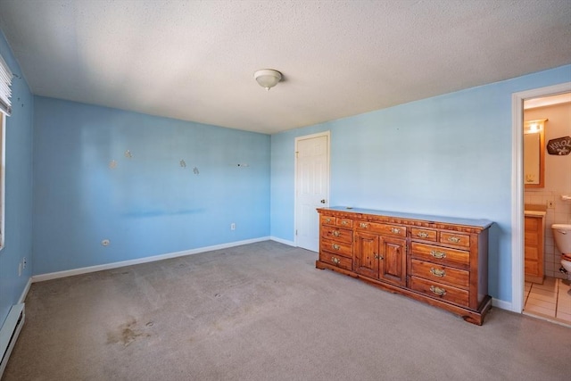 interior space with connected bathroom, a textured ceiling, carpet flooring, and a baseboard radiator