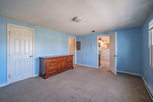 unfurnished bedroom featuring a baseboard radiator, baseboards, carpet, and a textured ceiling