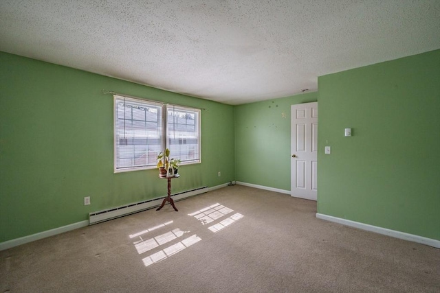 empty room featuring baseboard heating, carpet flooring, a textured ceiling, and baseboards