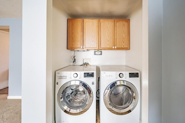 washroom with cabinet space, independent washer and dryer, baseboards, and carpet