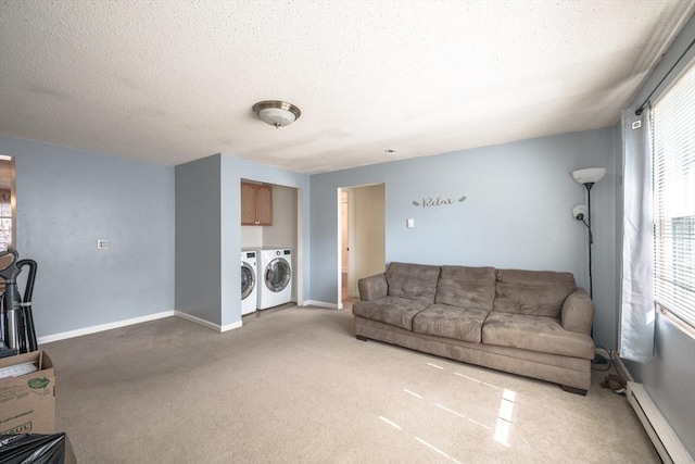 living area with baseboards, carpet floors, a baseboard radiator, a textured ceiling, and washer and dryer