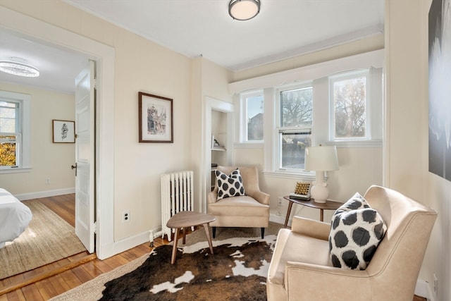 sitting room featuring radiator and hardwood / wood-style floors