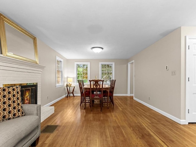 182 W Main St, Westborough, MA 01581 - dining room featuring wood finished floors, baseboards, and a brick fireplace