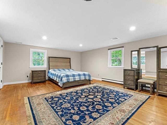 182 W Main St, Westborough, MA 01581 - bedroom featuring baseboard heating, wood finished floors, baseboards, and recessed lighting