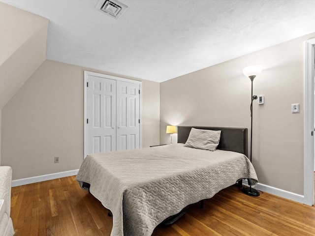 182 W Main St, Westborough, MA 01581 - bedroom with baseboards, wood finished floors, a closet, and lofted ceiling