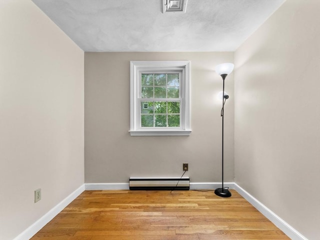 182 W Main St, Westborough, MA 01581 - unfurnished room with baseboard heating, baseboards, and wood finished floors