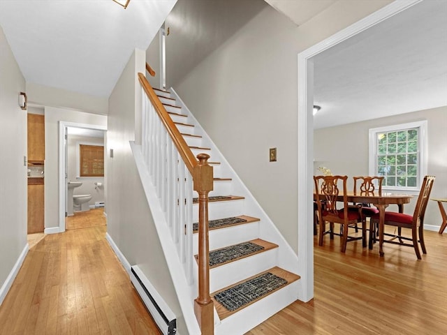 182 W Main St, Westborough, MA 01581 - stairs with a baseboard heating unit, wood finished floors, and baseboards
