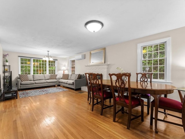 182 W Main St, Westborough, MA 01581 - dining space with a wall unit AC, wood finished floors, and a chandelier