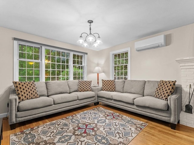 182 W Main St, Westborough, MA 01581 - living area featuring an AC wall unit, a chandelier, wood finished floors, and healthy amount of natural light