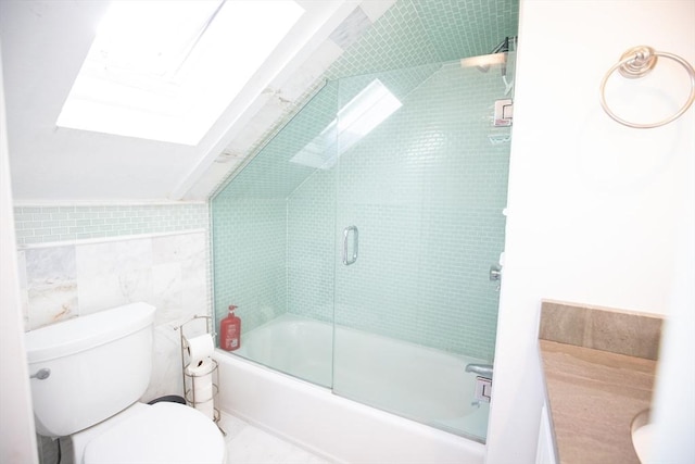 full bath with a skylight, tile walls, toilet, and combined bath / shower with glass door