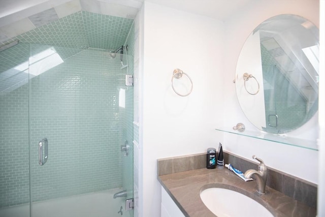 full bath featuring vanity and shower / bath combination with glass door