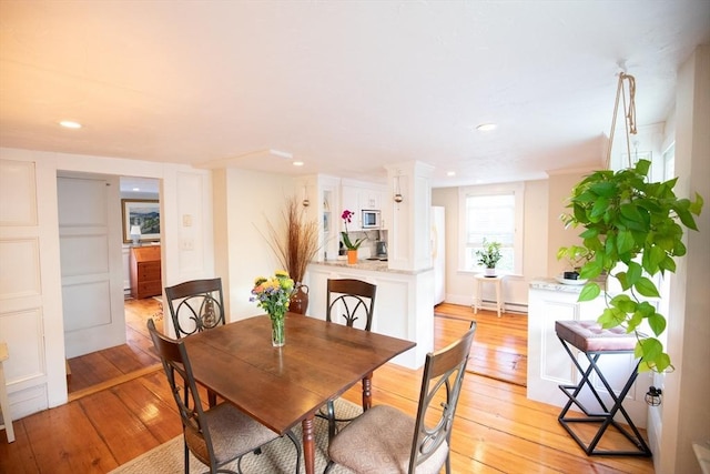 dining space with light wood-style flooring and recessed lighting