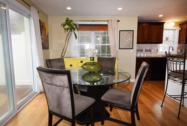 dining space with light wood-type flooring and recessed lighting