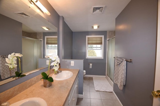 bathroom featuring plenty of natural light, a sink, and visible vents