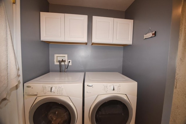 laundry room featuring cabinet space and washing machine and clothes dryer