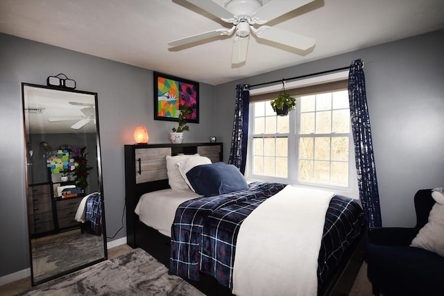 bedroom with ceiling fan and baseboards