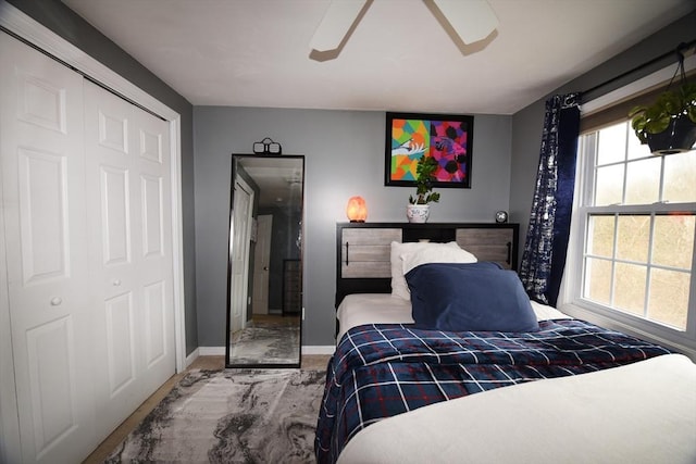 carpeted bedroom featuring ceiling fan and baseboards