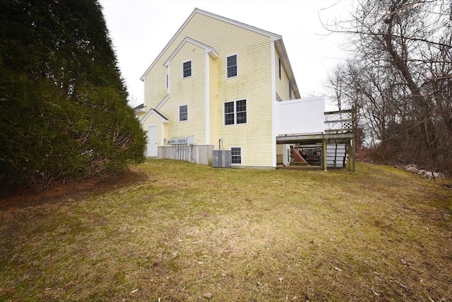 back of house with central air condition unit, stairway, a lawn, and a wooden deck