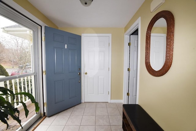 entrance foyer featuring baseboards and light tile patterned flooring