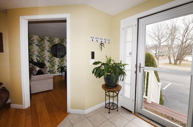 interior space with light wood finished floors, a wealth of natural light, and baseboards