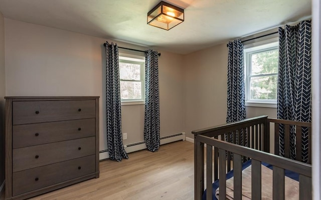 70 Oak St, Norton, MA 02766 - bedroom featuring light wood finished floors, baseboard heating, and a baseboard radiator