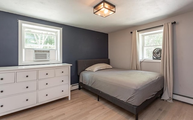 70 Oak St, Norton, MA 02766 - bedroom featuring a baseboard radiator, light wood-type flooring, and cooling unit