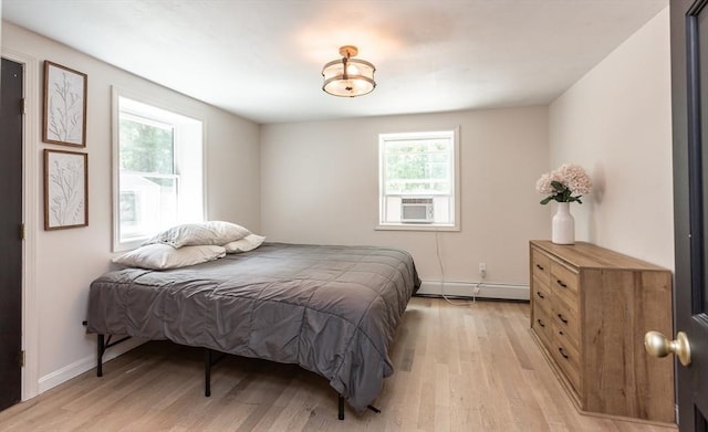70 Oak St, Norton, MA 02766 - bedroom featuring baseboard heating, light wood-style flooring, and cooling unit