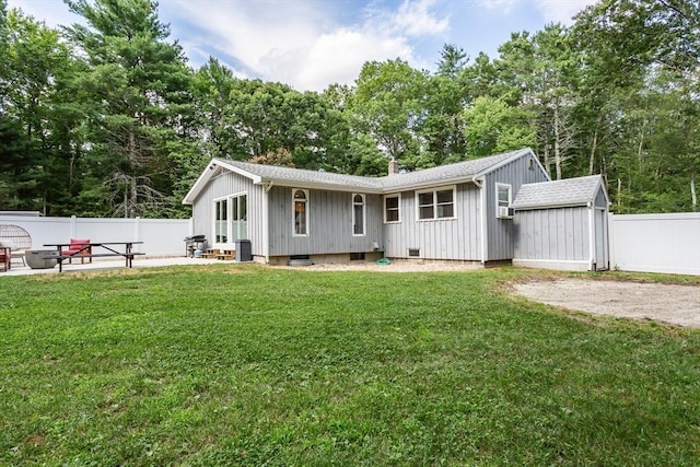70 Oak St, Norton, MA 02766 - rear view of house featuring a patio, a shingled roof, and board and batten siding