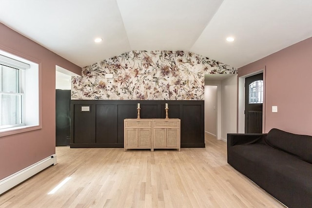 70 Oak St, Norton, MA 02766 - living area featuring a baseboard heating unit, wallpapered walls, vaulted ceiling, light wood finished floors, and an accent wall