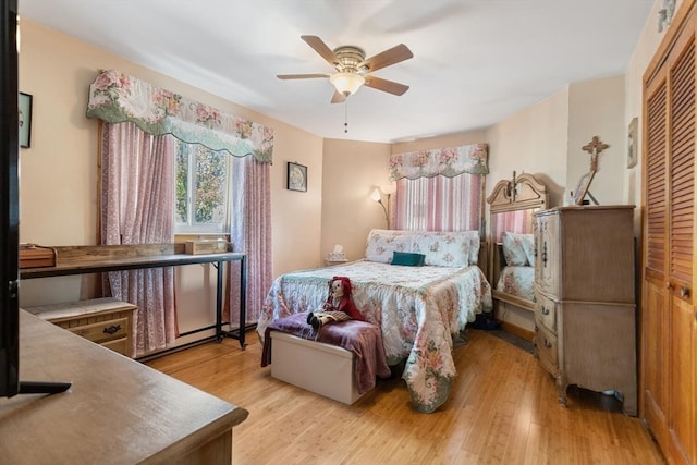 bedroom with ceiling fan, light wood-type flooring, and a closet